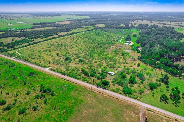a view of a green field with an ocean view