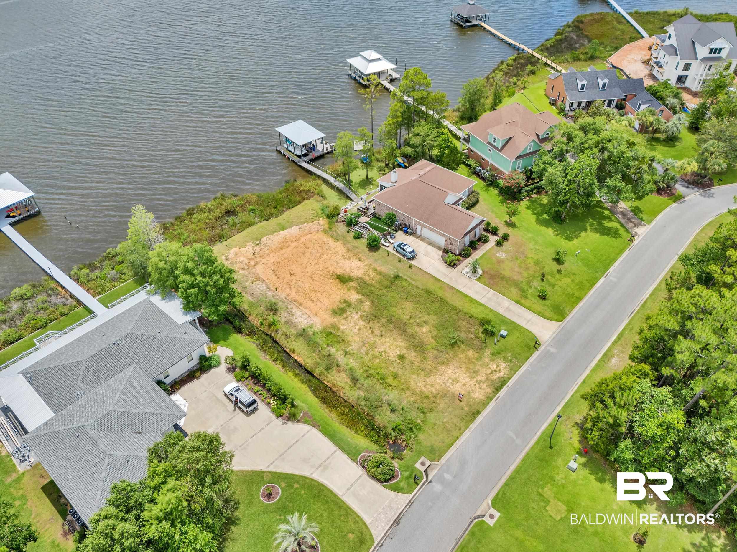 8963 Bay Point Drive Elberta, AL 36530 - Photo 5 of 25 Aerial perspective of suburban area with a large body of water