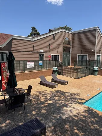 a view of a swimming pool with a yard and sitting area