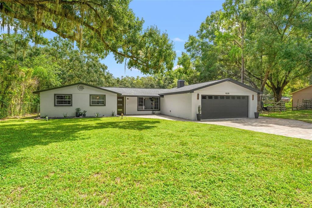 18205 Griffith Road Lutz, FL 33548 - Photo 1 of 1 a front view of house with yard and green space
