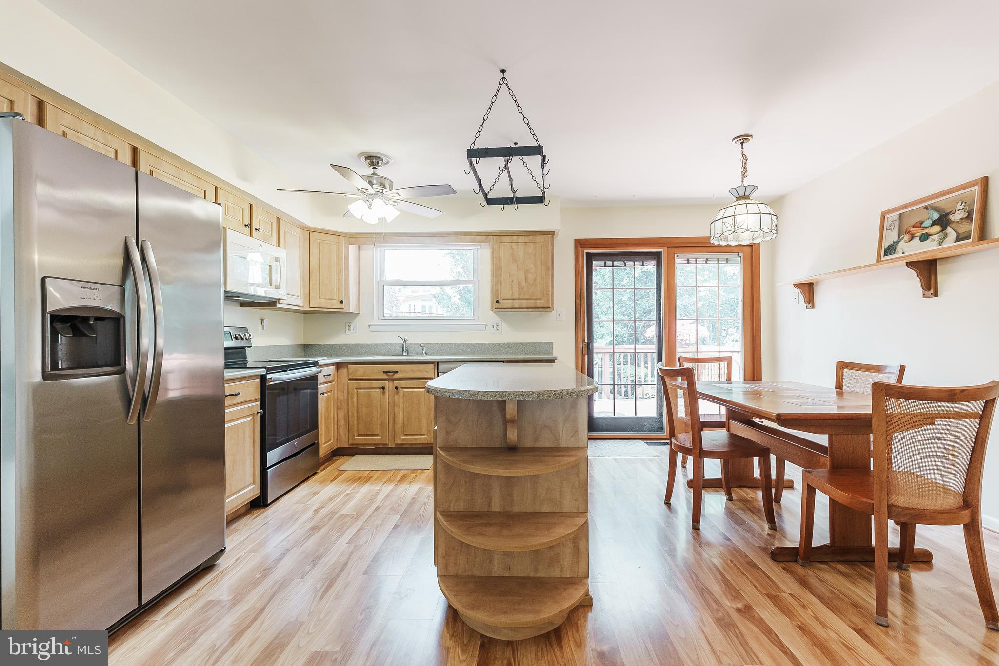 12 Victoria Court Mount Laurel, NJ 08054 - Photo 5 of 31 a kitchen with stainless steel appliances granite countertop a refrigerator a stove top oven a dining table and chairs with wooden floor