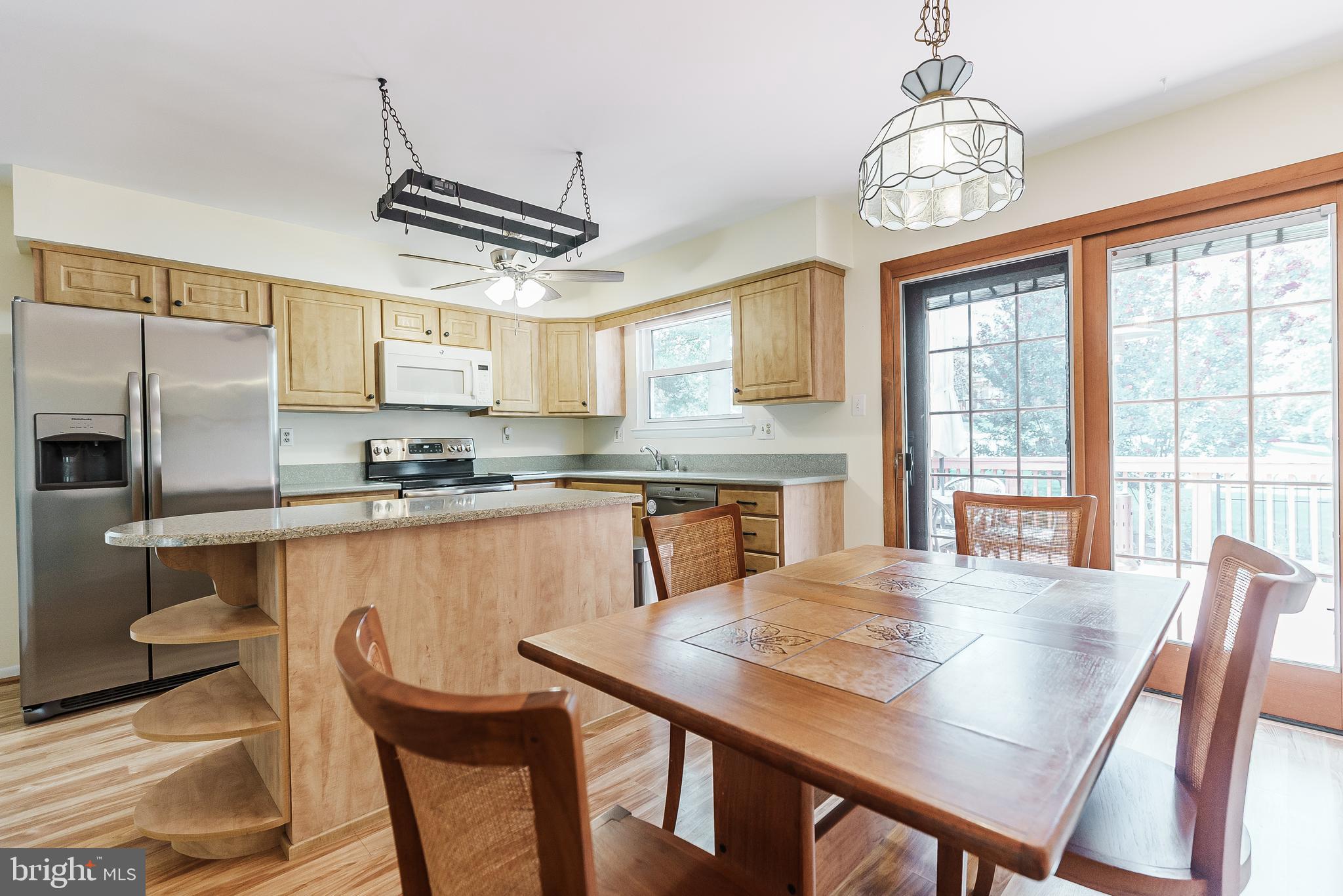 12 Victoria Court Mount Laurel, NJ 08054 - Photo 6 of 31 a kitchen with stainless steel appliances granite countertop a dining table chairs refrigerator and cabinets