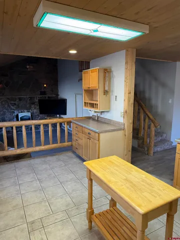 a kitchen with stainless steel appliances a stove a sink cabinets and a dining table