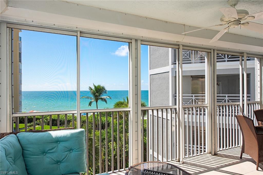 9155 Gulf Shore Drive, Unit 401 Naples, FL 34108 - Photo 2 of 12 a living room filled with furniture