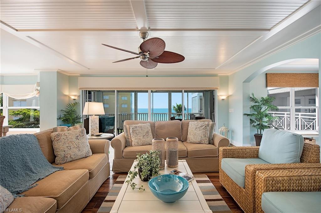 9155 Gulf Shore Drive, Unit 401 Naples, FL 34108 - Photo 4 of 12 a living room with furniture and a large window