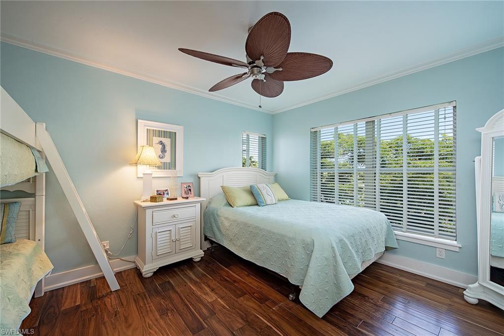 9155 Gulf Shore Drive, Unit 401 Naples, FL 34108 - Photo 9 of 12 a bedroom with a bed and a large window