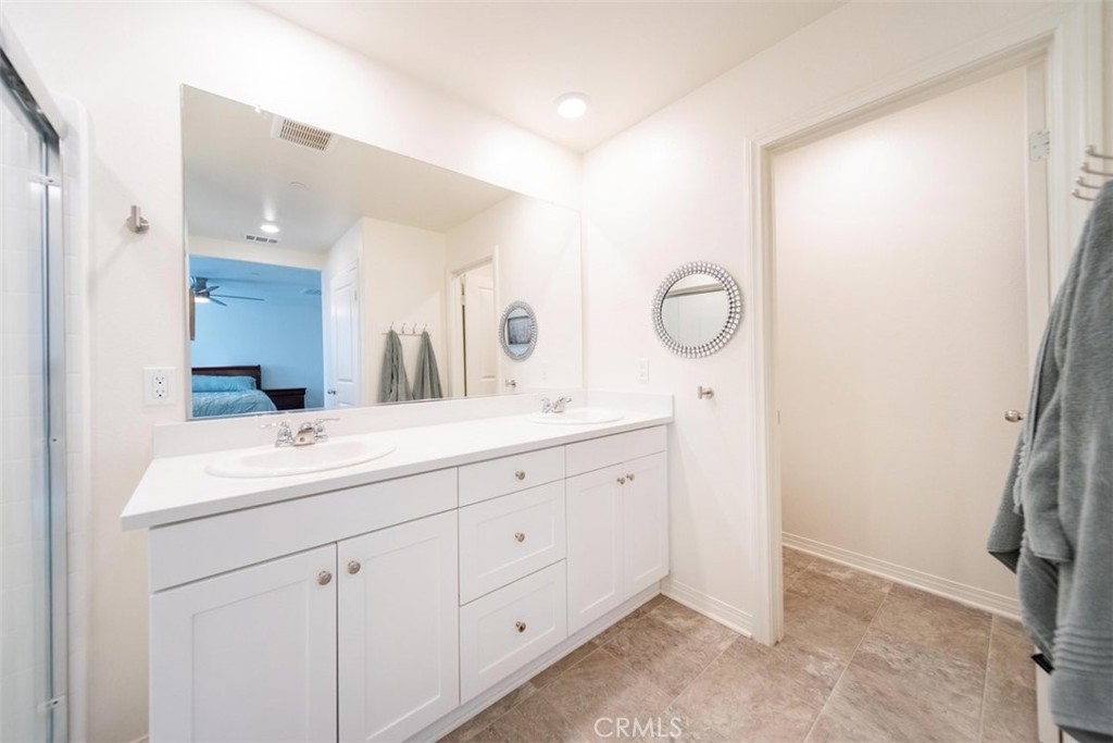 32078 Rambling Court Winchester, CA 92596 - Photo 29 of 48 a bathroom with a double vanity sink and a mirror
