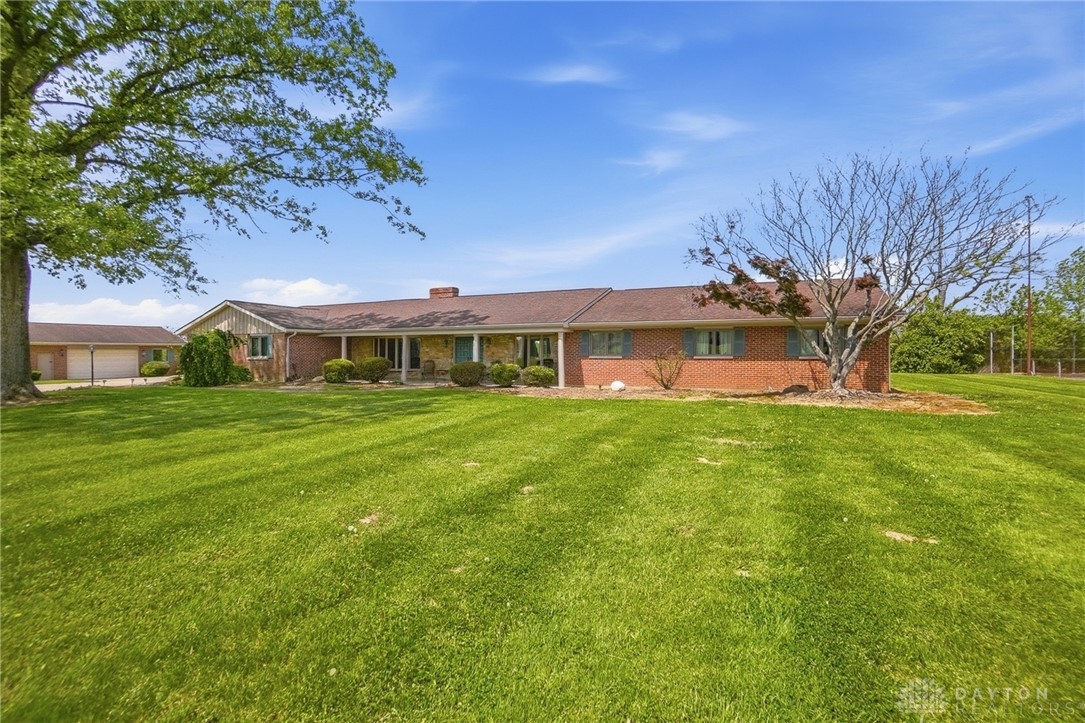 5669 O Neall Road Waynesville, OH 45068 - Photo 15 of 72 This spacious brick ranch home features a charming porch and expansive green lawn.