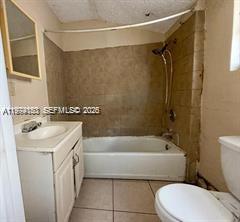 2228 Southwest 2nd Street Miami, FL 33135 - Photo 11 of 19 a bathroom with a sink a toilet and a bathtub