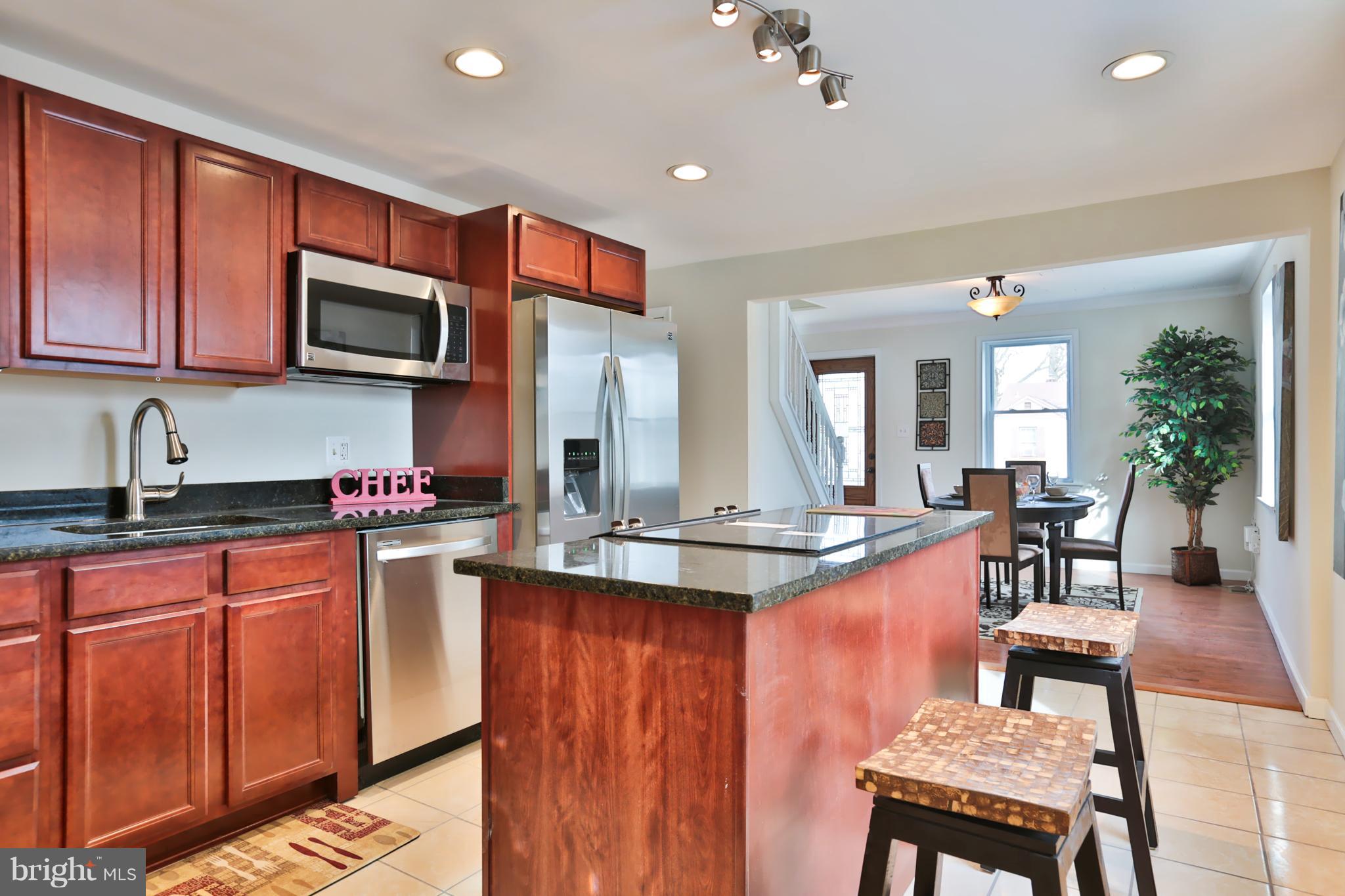 4115 Klausmier Road Baltimore, MD 21236 - Photo 11 of 30 a kitchen with stainless steel appliances granite countertop a sink dishwasher a microwave oven with granite countertops and cabinets