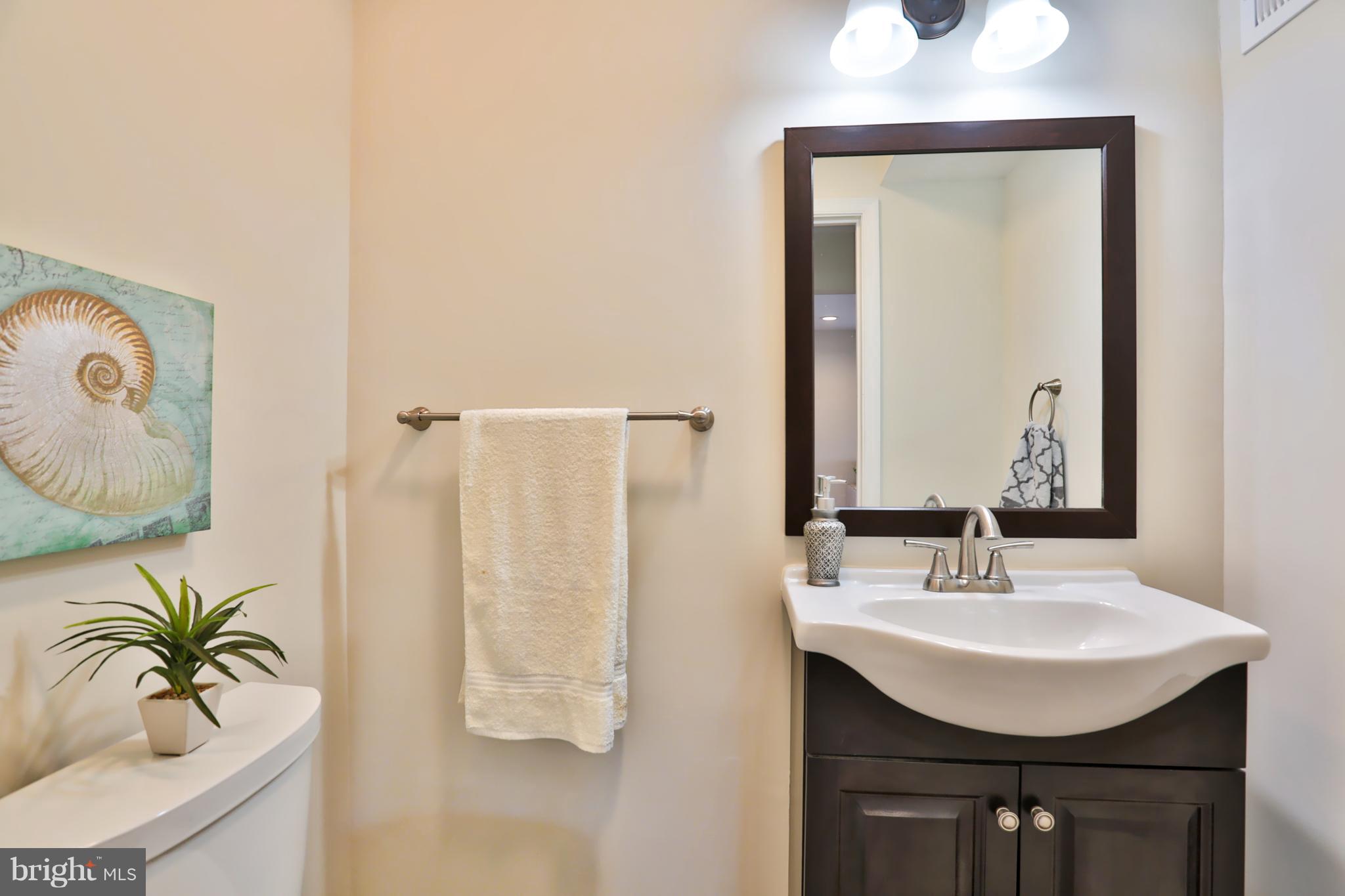 4115 Klausmier Road Baltimore, MD 21236 - Photo 13 of 30 a bathroom with a sink a mirror and a shower