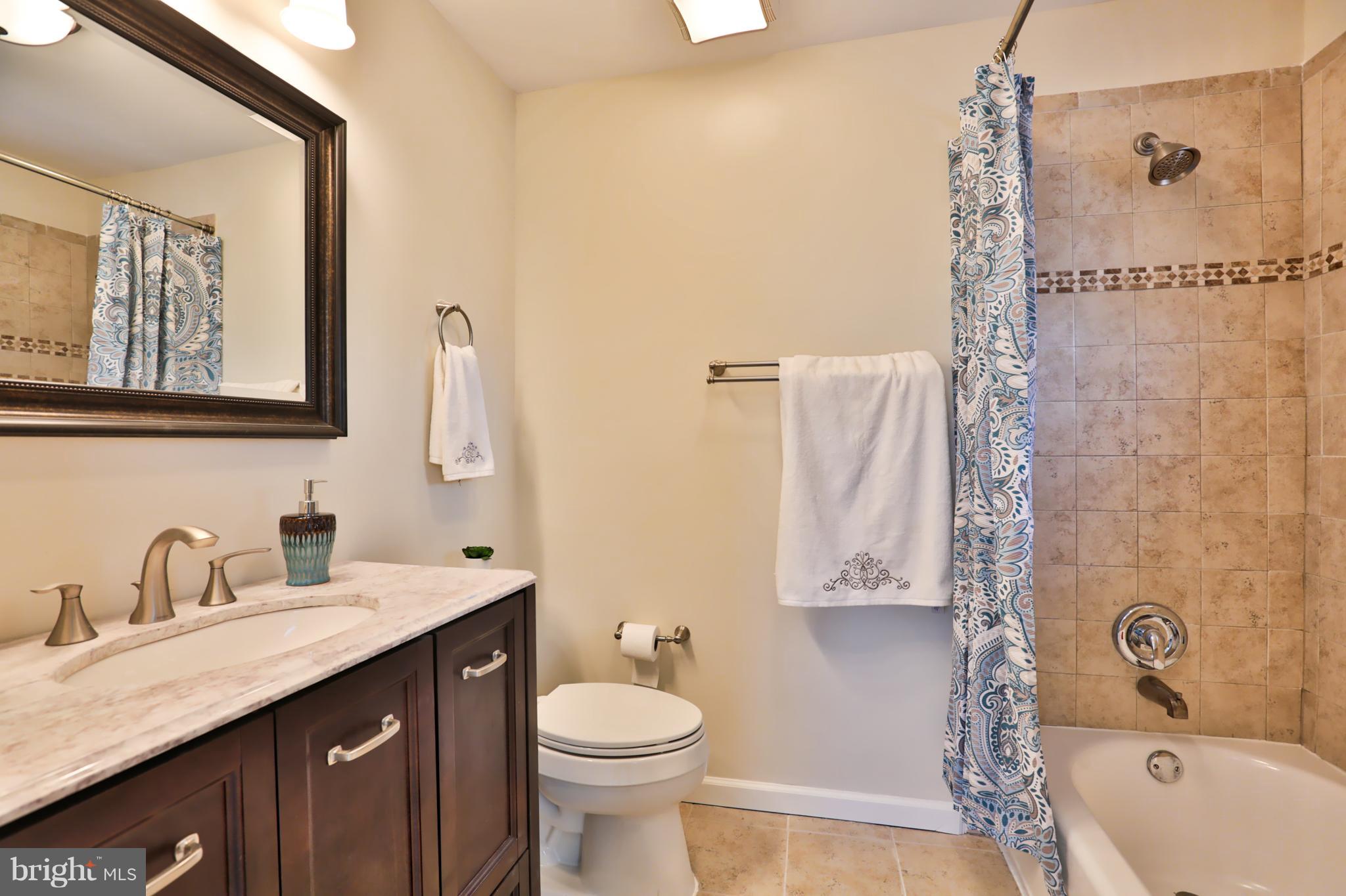 4115 Klausmier Road Baltimore, MD 21236 - Photo 18 of 30 a bathroom with a double vanity sink toilet mirror and shower