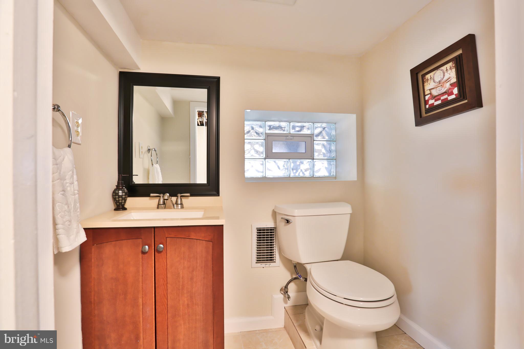 4115 Klausmier Road Baltimore, MD 21236 - Photo 22 of 30 a bathroom with a toilet a sink and mirror