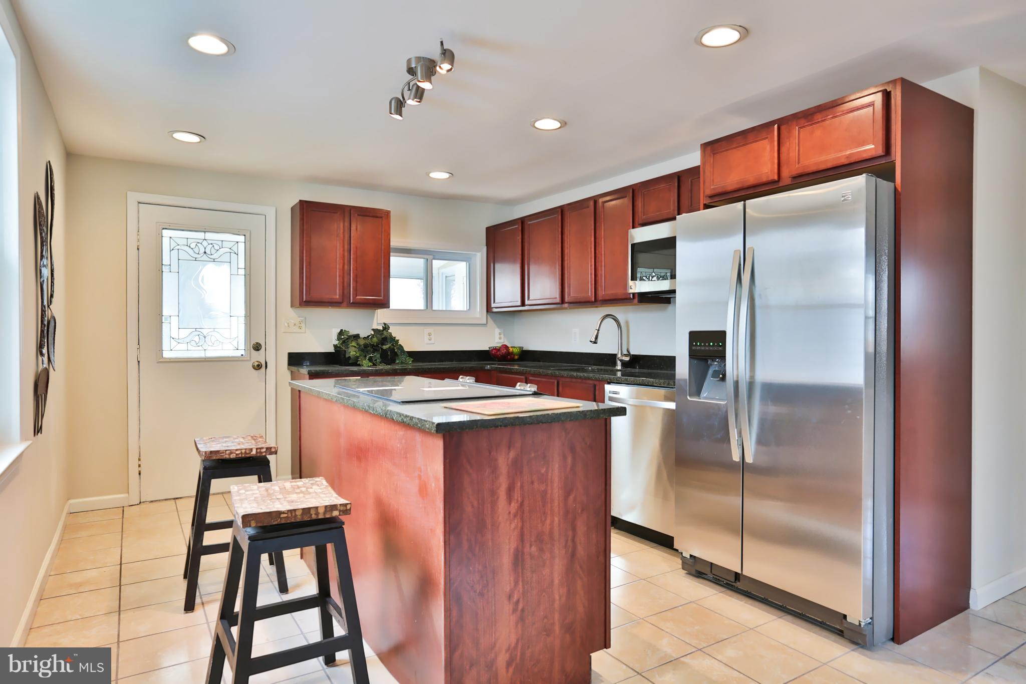 4115 Klausmier Road Baltimore, MD 21236 - Photo 10 of 30 a kitchen with stainless steel appliances granite countertop a refrigerator and a stove top oven