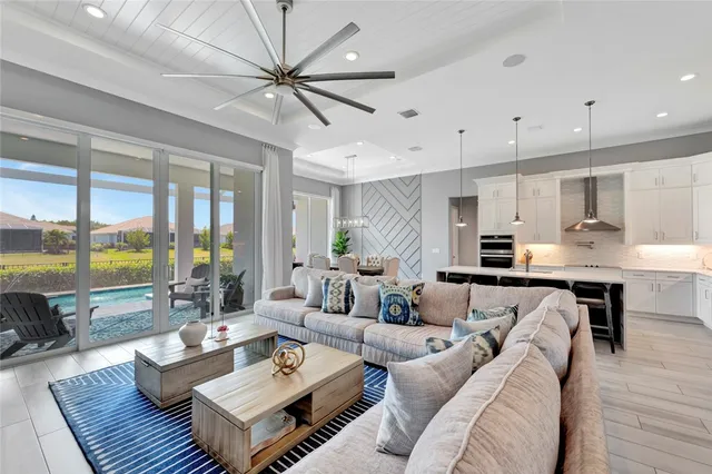 a living room with furniture and a large window with outer view