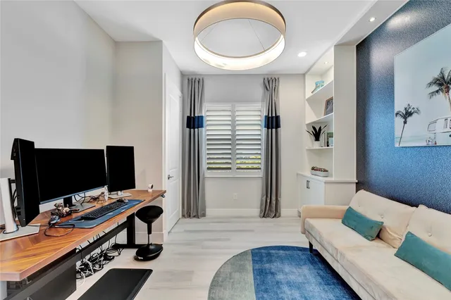 a large bedroom with a large bed and a chandelier