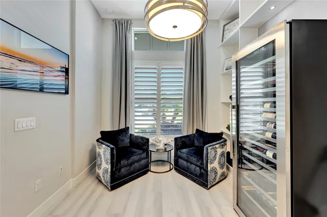 a view of hall way with furniture and chandelier fan