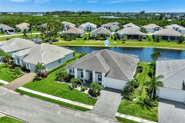 an aerial view of residential houses with outdoor space and parking