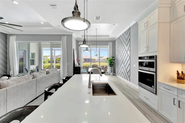 a large white kitchen with a large window