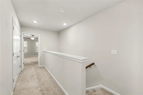 a view of a hallway with a white walls