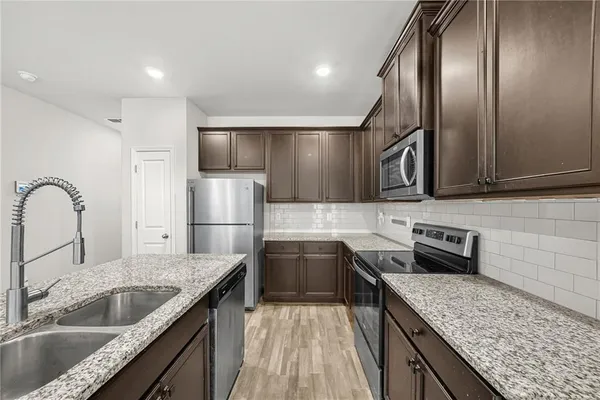 a kitchen that has a sink and a stove