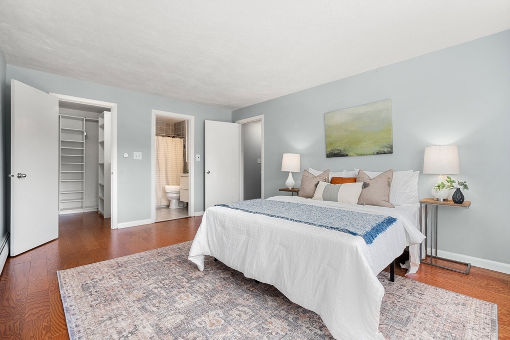 32 Whites Avenue, Unit E441 Watertown, MA 02472 - Photo 13 of 34 a spacious bedroom with a bed and wooden floor