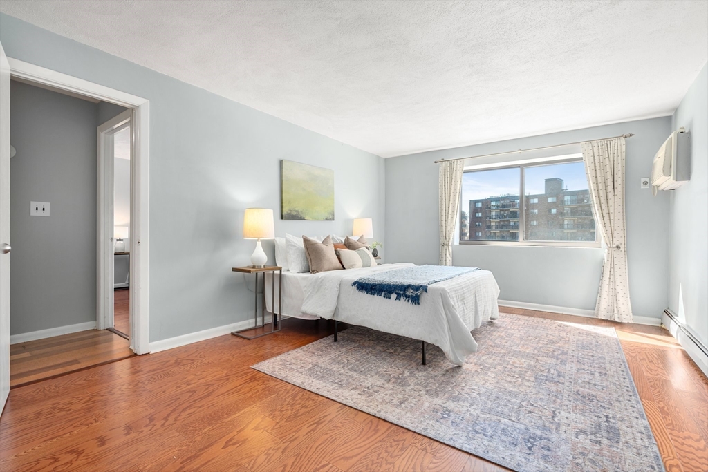 32 Whites Avenue, Unit E441 Watertown, MA 02472 - Photo 14 of 34 a spacious bedroom with a bed and a window
