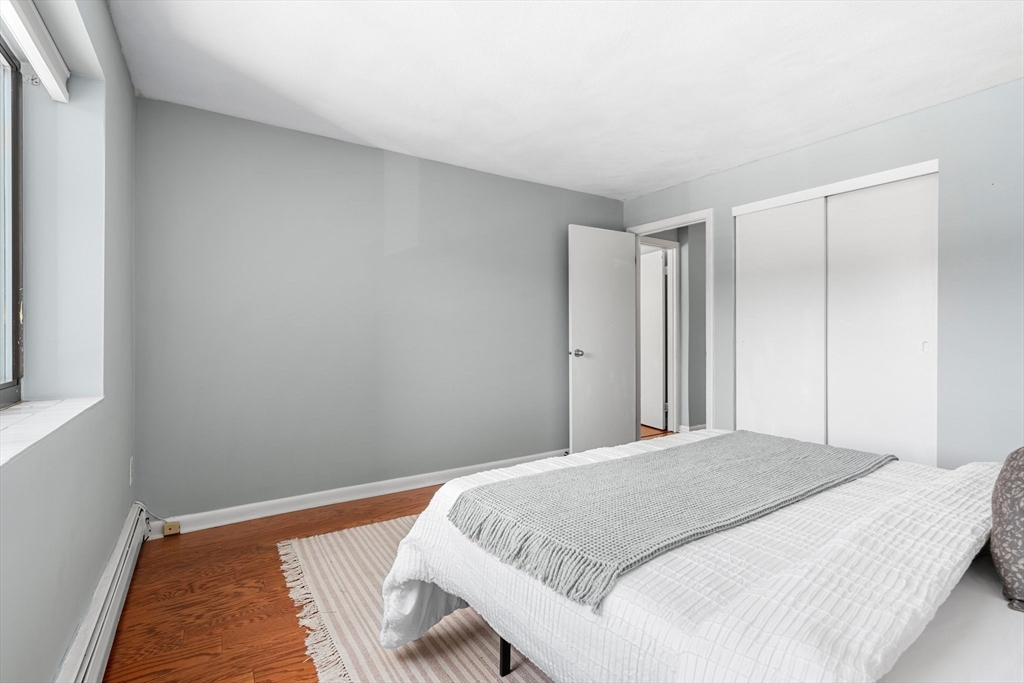 32 Whites Avenue, Unit E441 Watertown, MA 02472 - Photo 17 of 34 a bedroom with a bed and a window