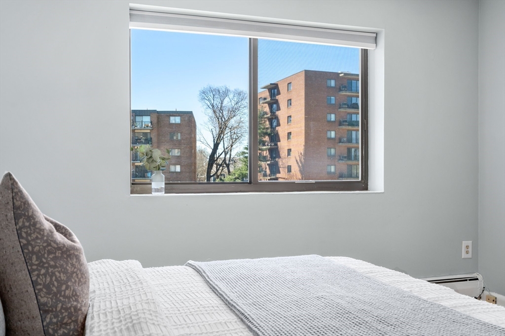 32 Whites Avenue, Unit E441 Watertown, MA 02472 - Photo 22 of 34 a bedroom with a bed and a window