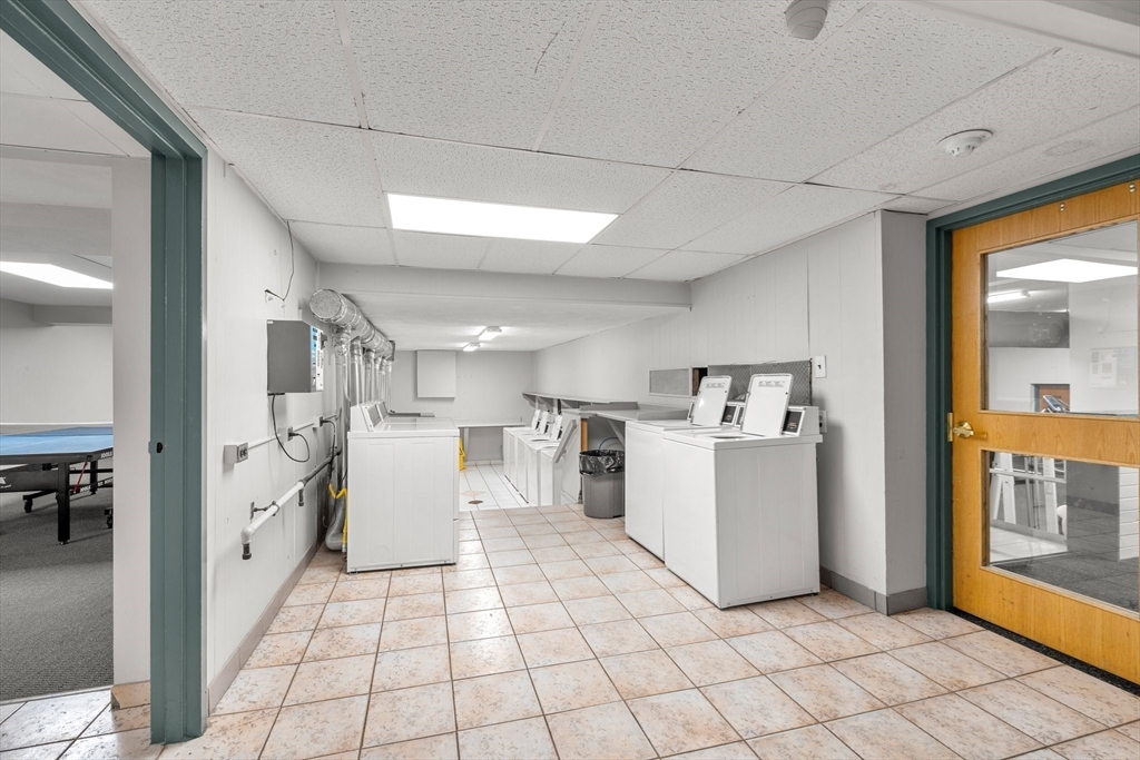 32 Whites Avenue, Unit E441 Watertown, MA 02472 - Photo 27 of 34 a view of a kitchen with fridge and furniture