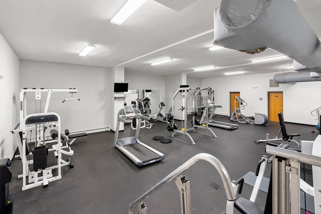 32 Whites Avenue, Unit E441 Watertown, MA 02472 - Photo 28 of 34 a view of a room with gym equipment