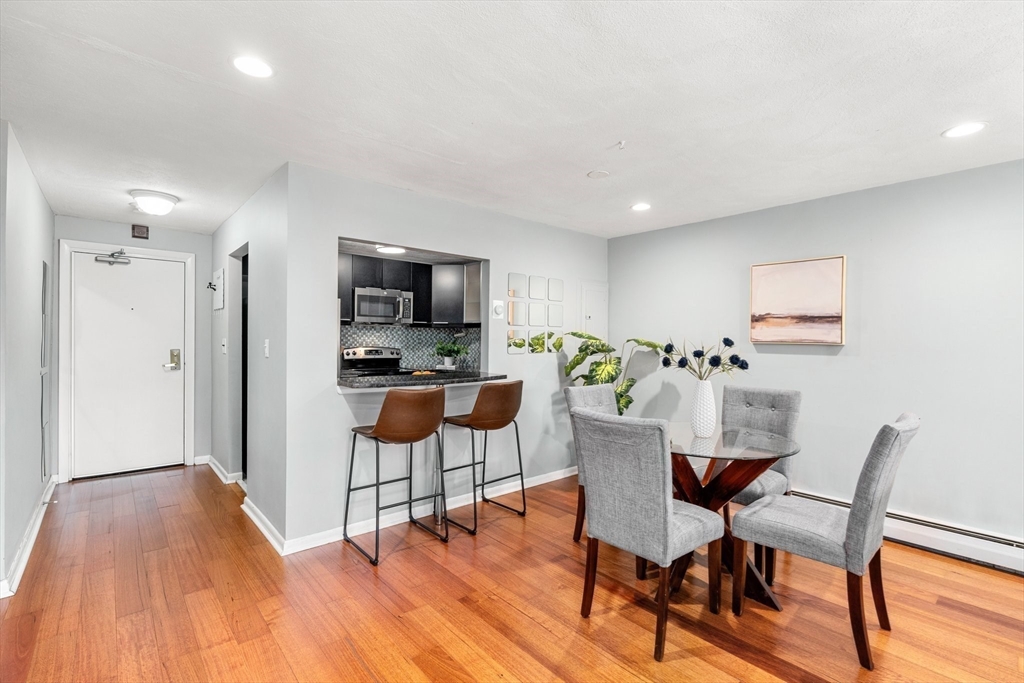 32 Whites Avenue, Unit E441 Watertown, MA 02472 - Photo 5 of 34 a view of a dining room with furniture and wooden floor