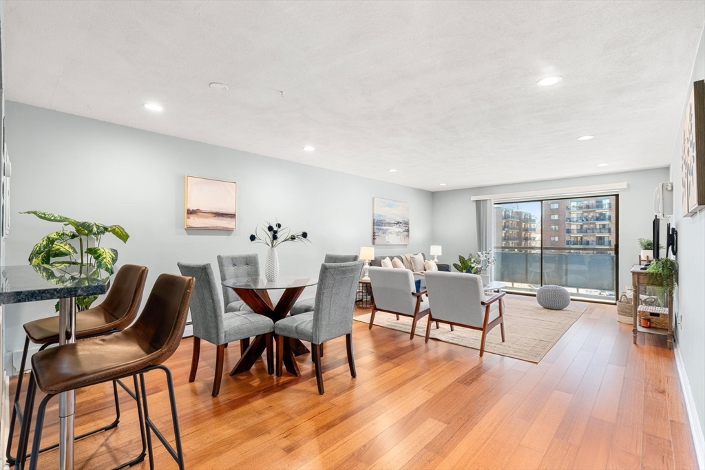 32 Whites Avenue, Unit E441 Watertown, MA 02472 - Photo 6 of 34 a living room with furniture dining table and a potted plant