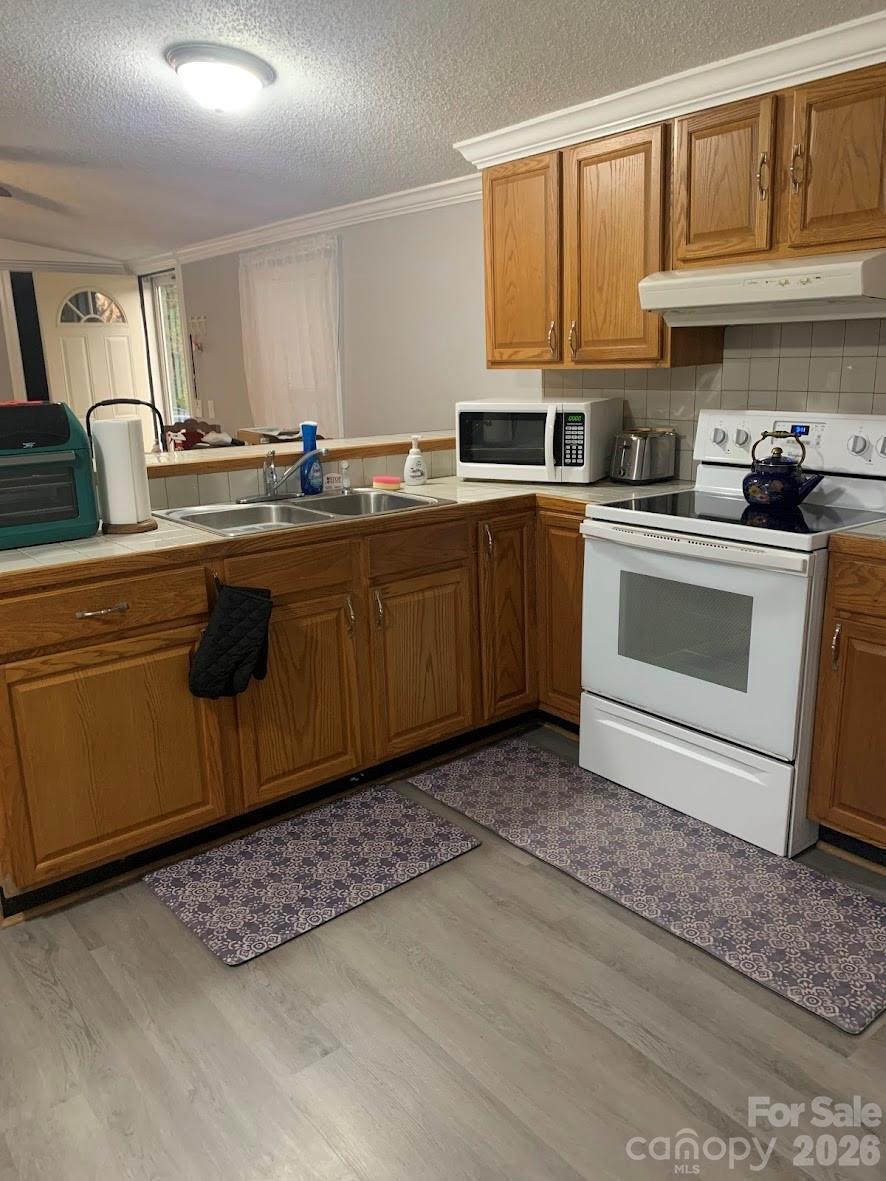 2595 Southmont Road Iron Station, NC 28080 - Photo 3 of 10 a kitchen with sink cabinets and window