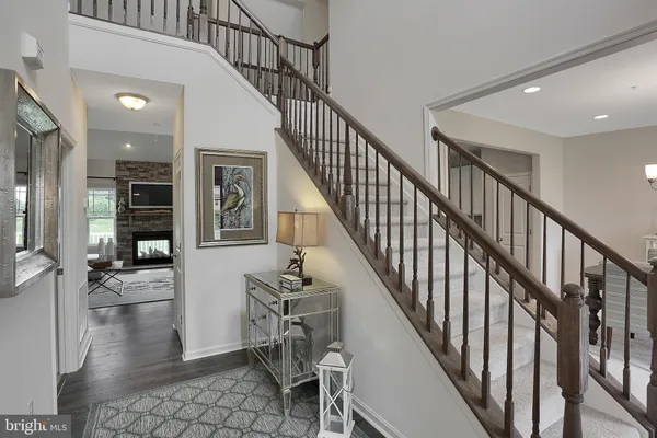 a view of entryway and hall with wooden floor