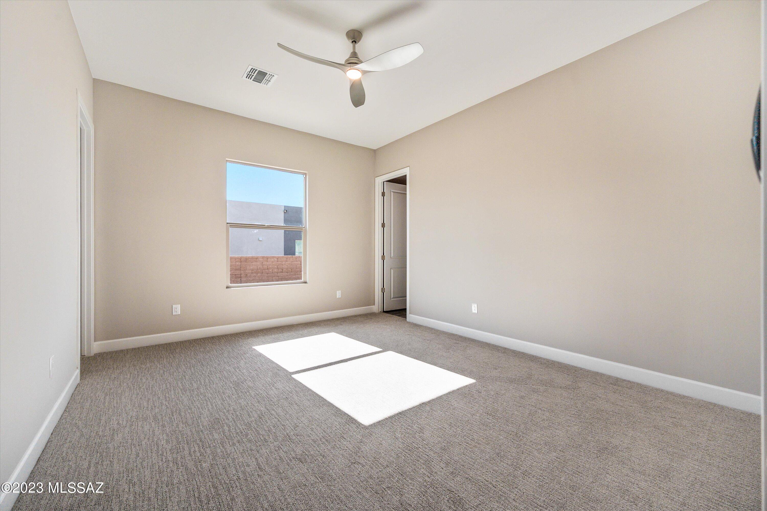 13169 North Vistoso Rnch Place Oro Valley, AZ 85755 - Photo 19 of 29 an empty room with windows and ceiling fan