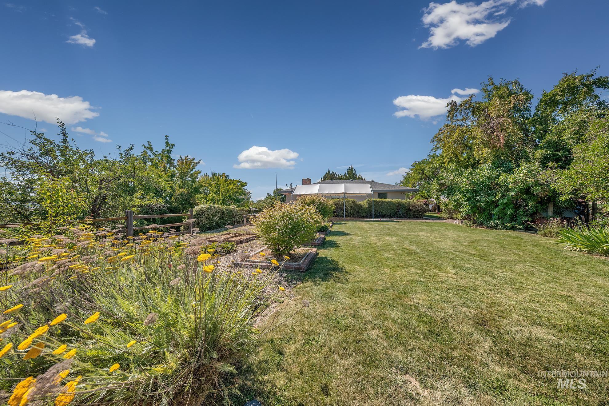 1493 Cove Road Weiser, ID 83672 - Photo 45 of 50 Expansive lawn area bordered by mature trees and shrubs