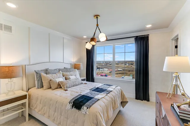 a bedroom with a large bed and a window
