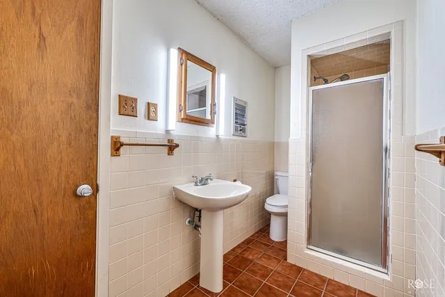 a view of empty room with wooden floor and windows