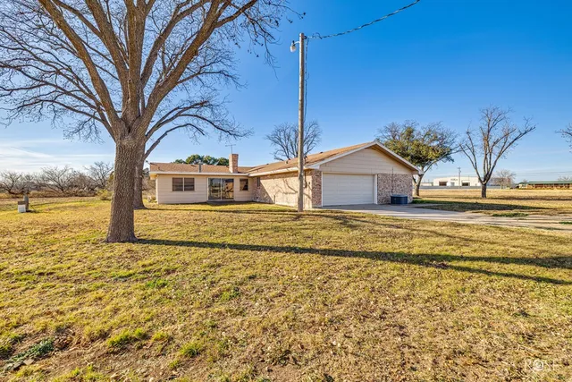 a view of a backyard of the house