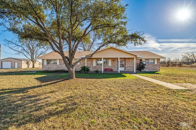 a view of house with yard