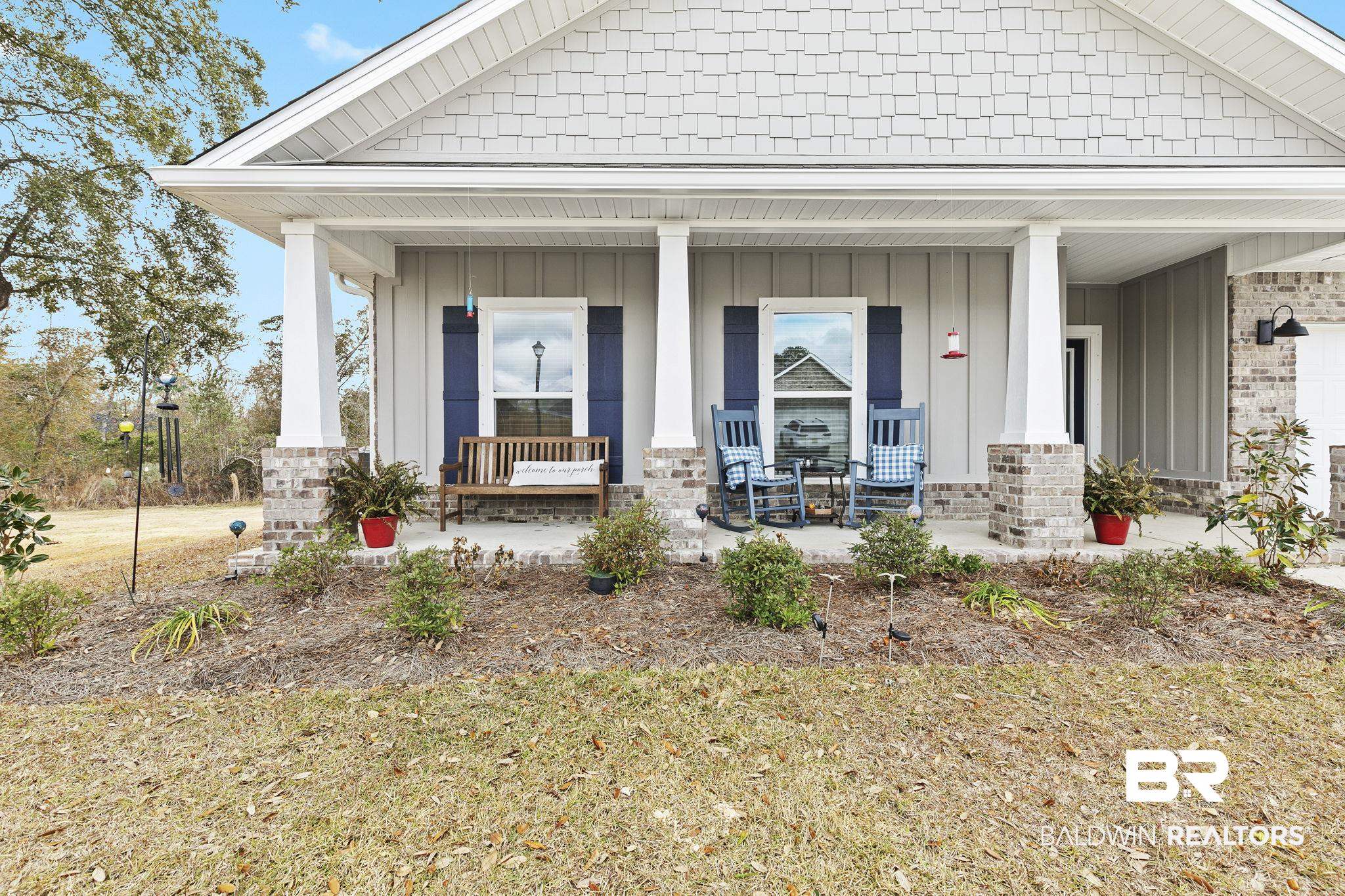 1141 Pencarro Boulevard Foley, AL 36535 - Photo 53 of 70 View of front of home featuring a porch and a front yard