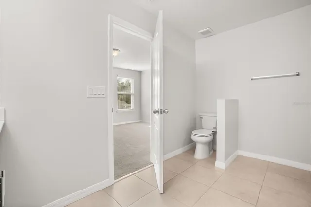 a bathroom with a granite countertop toilet and a shower
