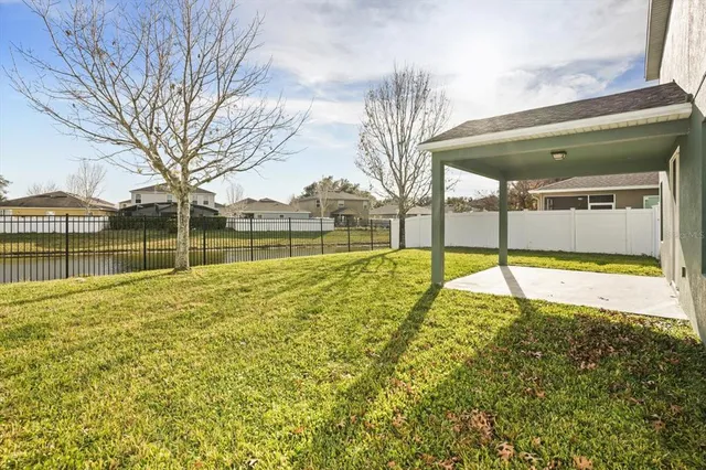 a view of a swimming pool with a yard