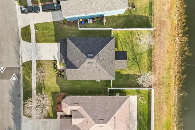 aerial view of a house with a yard