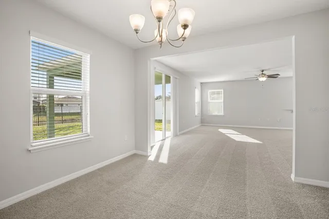 an empty room with windows and entrance