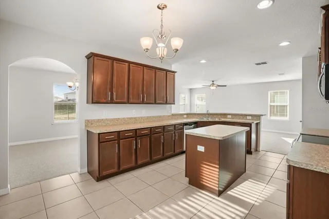 a kitchen with stainless steel appliances granite countertop a sink and a stove