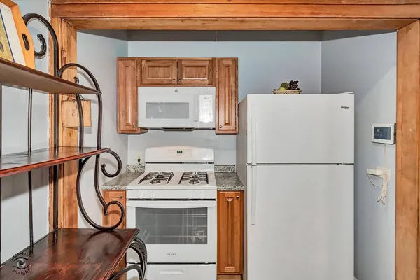 a white refrigerator freezer sitting next to a window