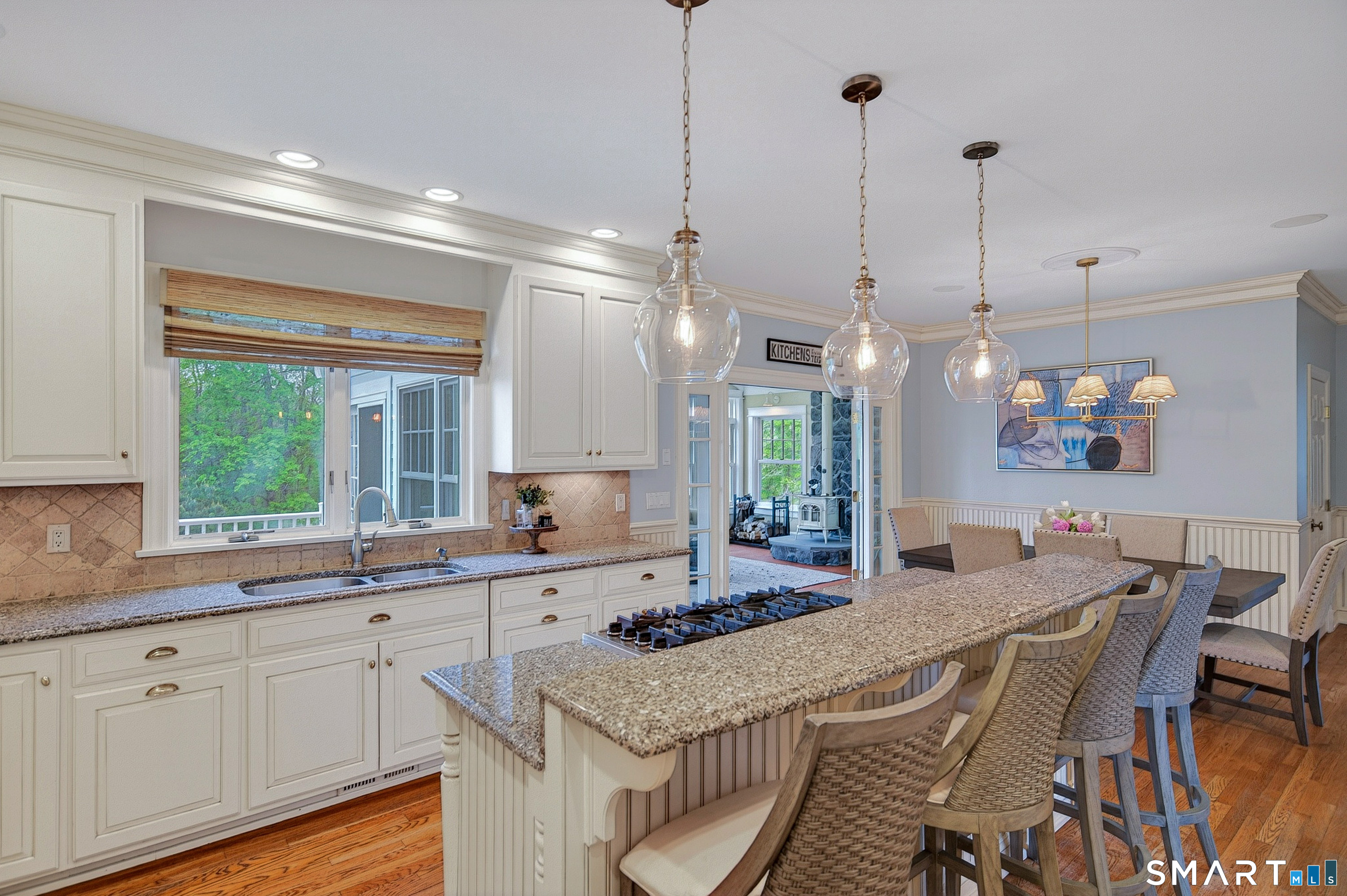 16 Farm Meadow Road Newtown, CT 06470 - Photo 6 of 40 Bright and inviting kitchen with breakfast seating, pendant lighting, granite countertops, and views into the dining area.