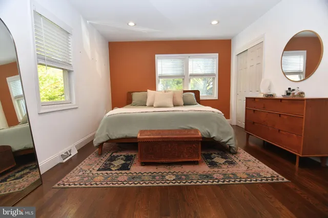 a bed sitting in a bedroom next to a window